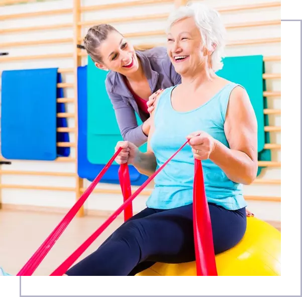 A woman and an older lady are sitting on a ball