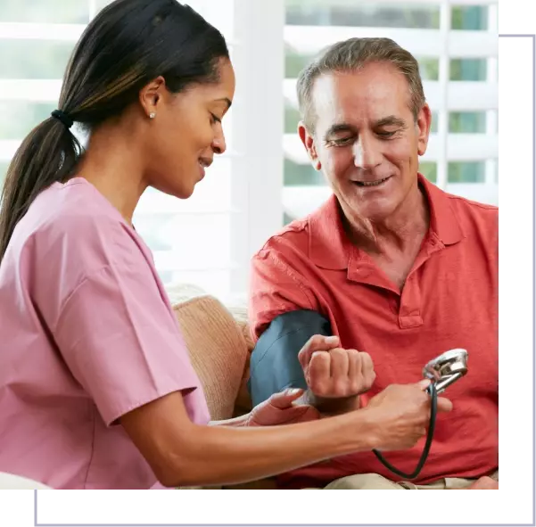 A nurse checking the blood pressure of an older man.