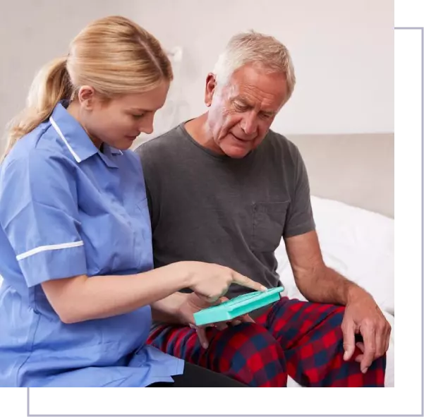 A nurse showing an elderly man something on his phone.