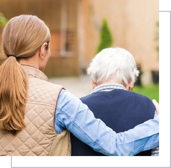 A woman holding an older man 's arm.